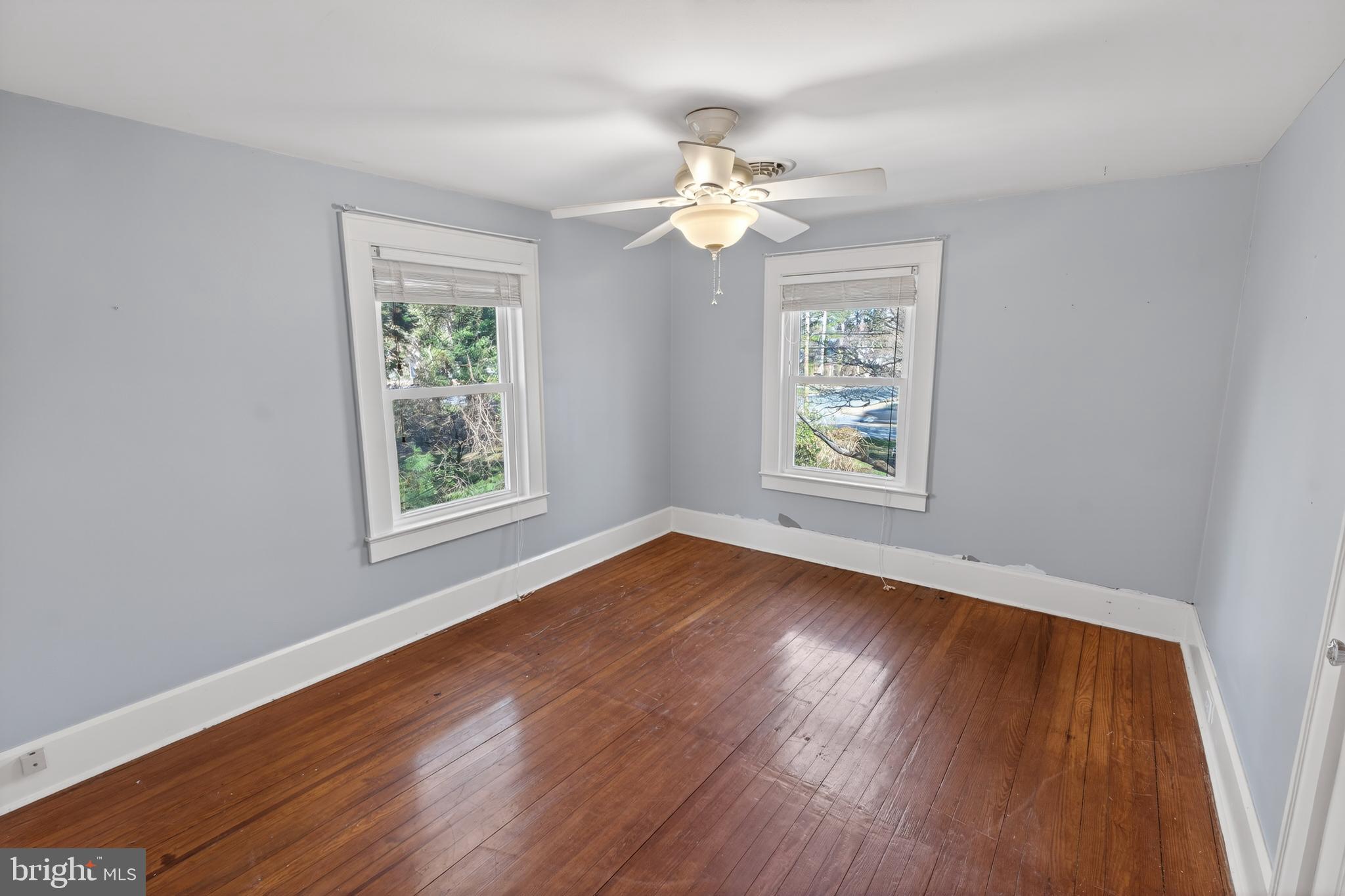 3202 Old Ocean City Road Salisbury, MD 21804 - Photo 22 of 29 a view of an empty room with wooden floor and a window