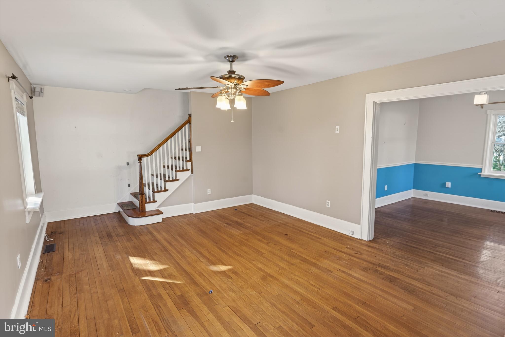3202 Old Ocean City Road Salisbury, MD 21804 - Photo 4 of 29 an empty room with wooden floor fan and windows