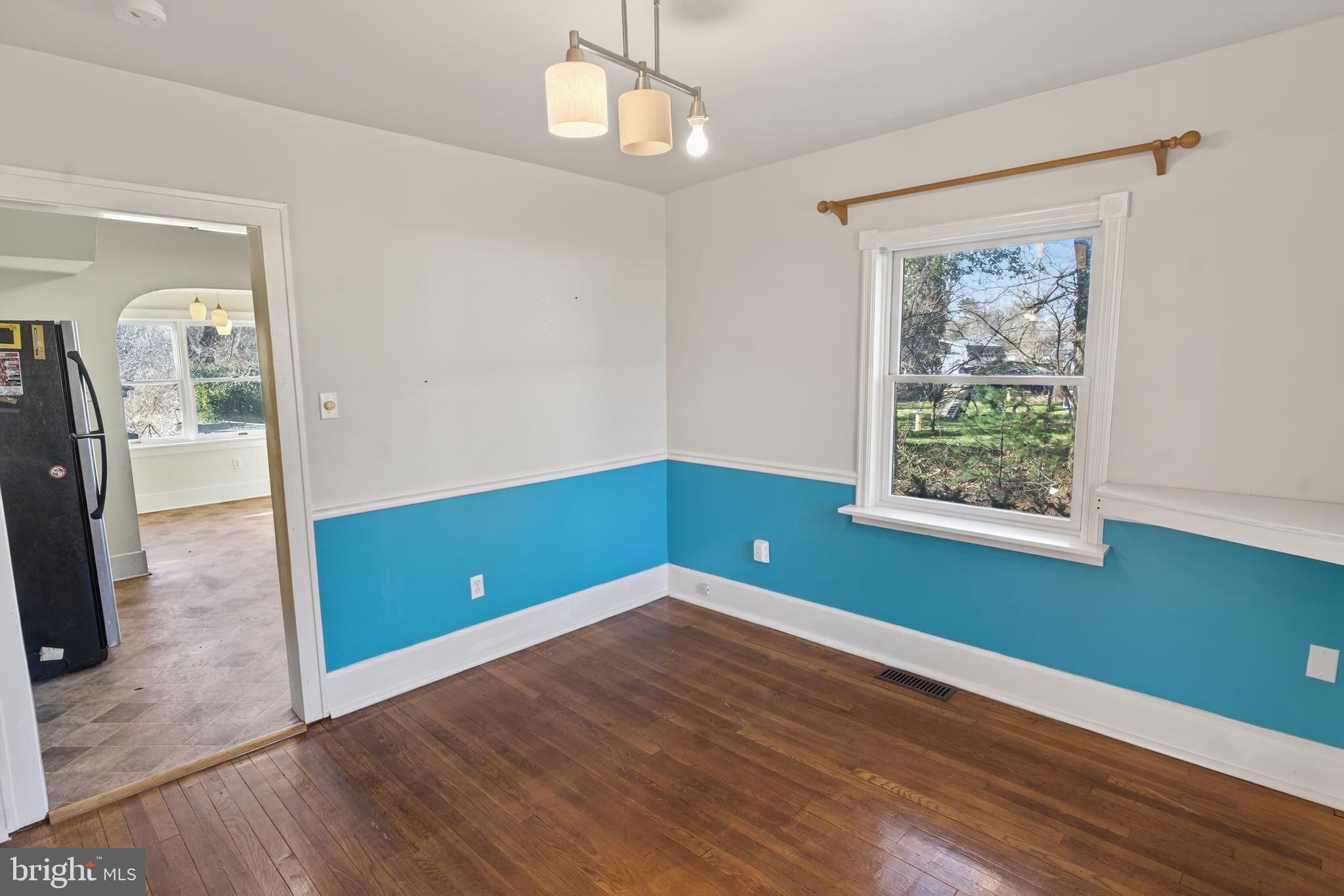 3202 Old Ocean City Road Salisbury, MD 21804 - Photo 6 of 29 a view of room with window ceiling fan and hardwood floor