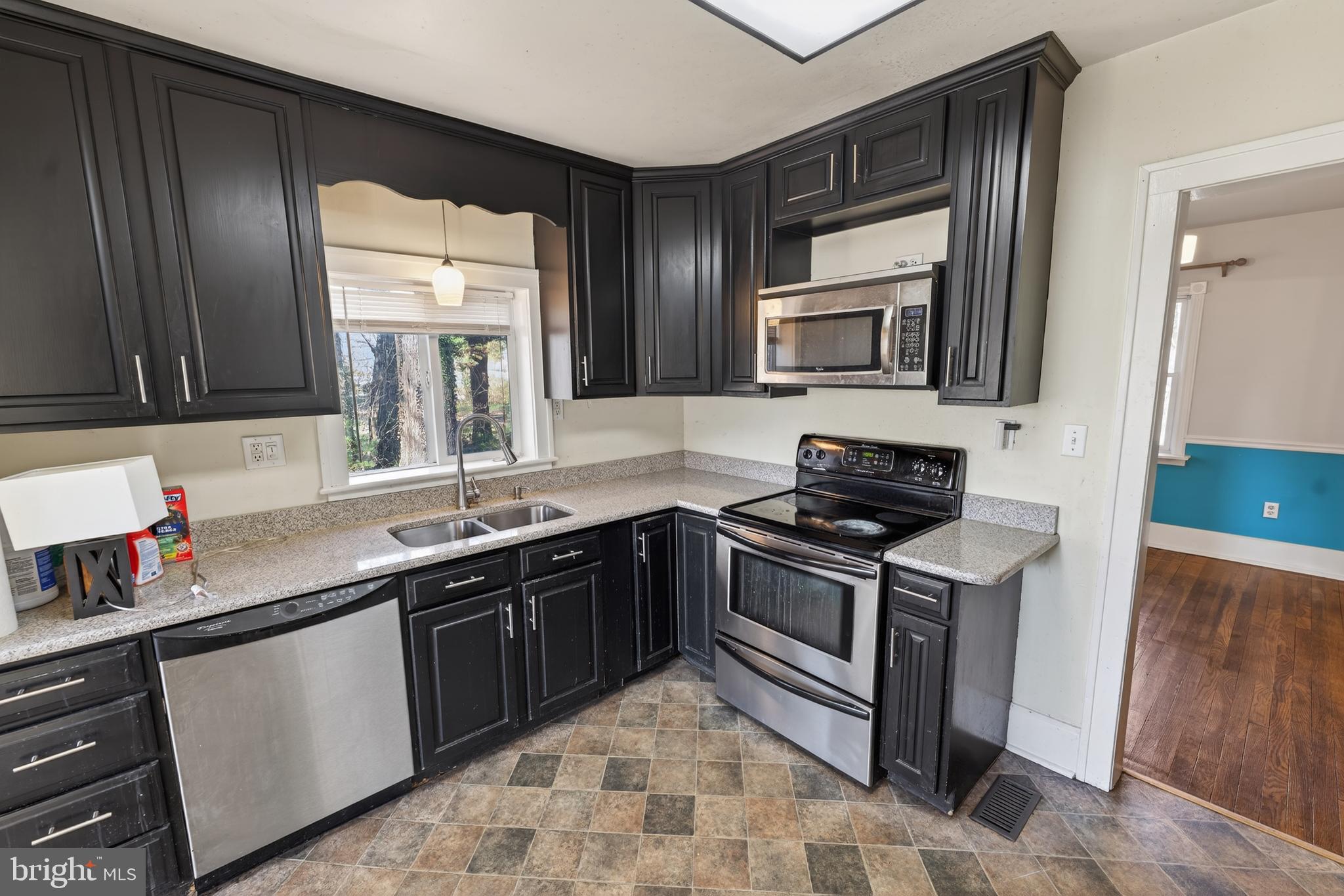3202 Old Ocean City Road Salisbury, MD 21804 - Photo 9 of 29 a kitchen with stainless steel appliances granite countertop a sink stove and microwave
