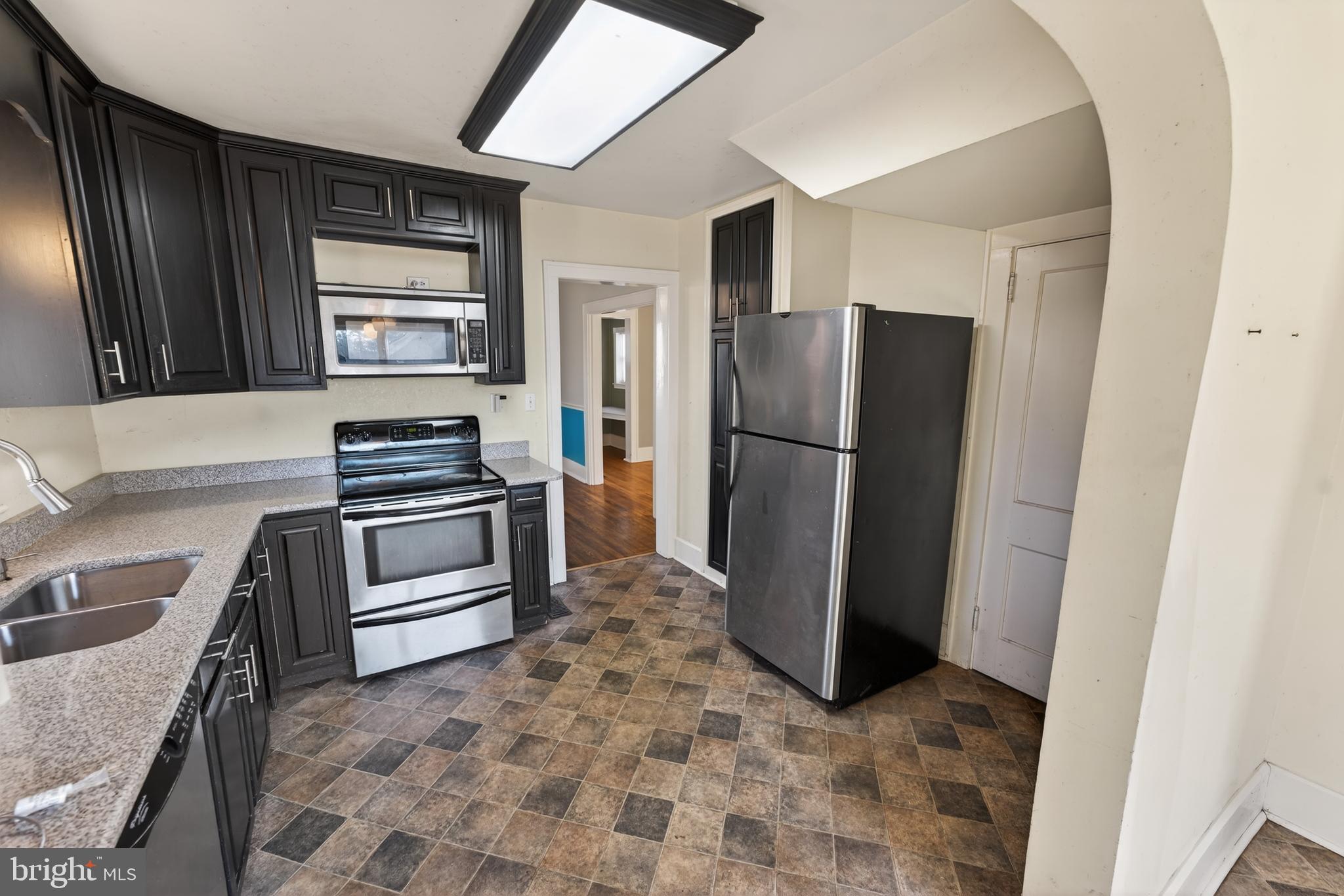 3202 Old Ocean City Road Salisbury, MD 21804 - Photo 10 of 29 a kitchen with granite countertop a refrigerator and a sink