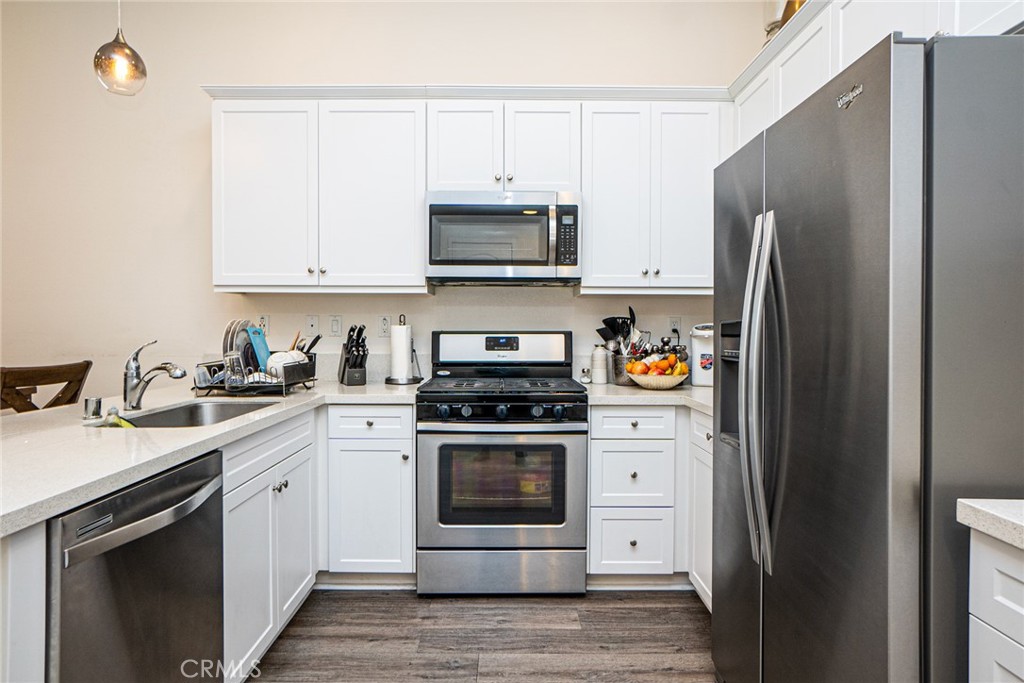 4956 Arrow, Unit B Montclair, CA 91763 - Photo 13 of 35 a kitchen with stainless steel appliances granite countertop a refrigerator stove and white cabinets
