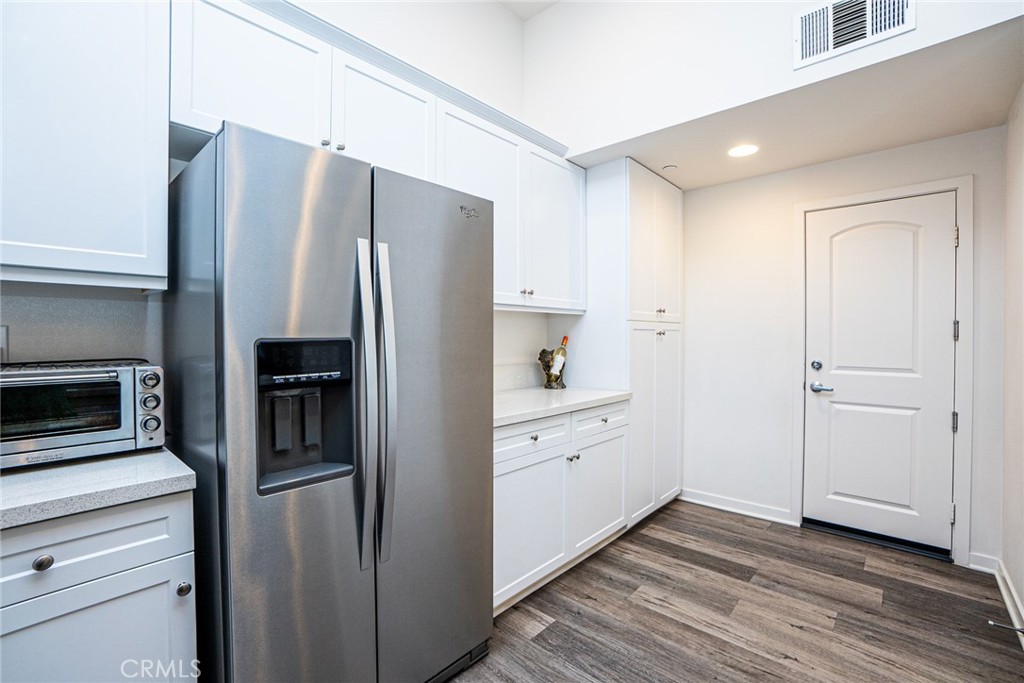 4956 Arrow, Unit B Montclair, CA 91763 - Photo 16 of 35 a kitchen with stainless steel appliances a refrigerator and cabinets
