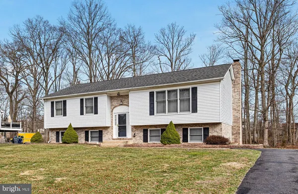 a house that has a tree in front of it