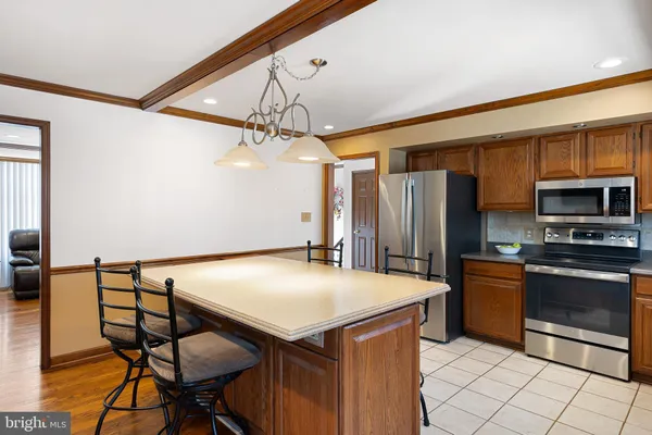 a kitchen with stainless steel appliances a stove a refrigerator and microwave