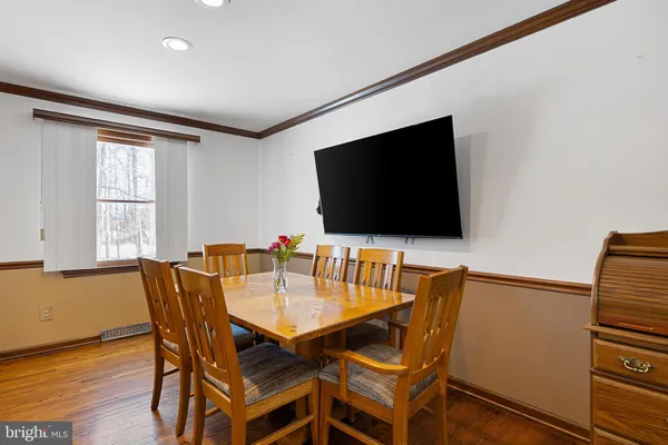 a view of a dining room with furniture and wooden floor
