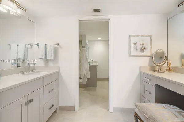 a bathroom with a double vanity sink and a mirror
