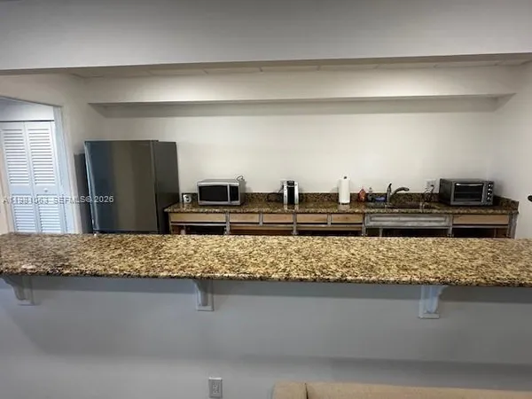 a living room with furniture and cabinet