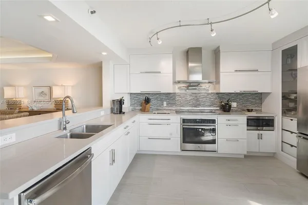 a kitchen with white cabinets and white appliances
