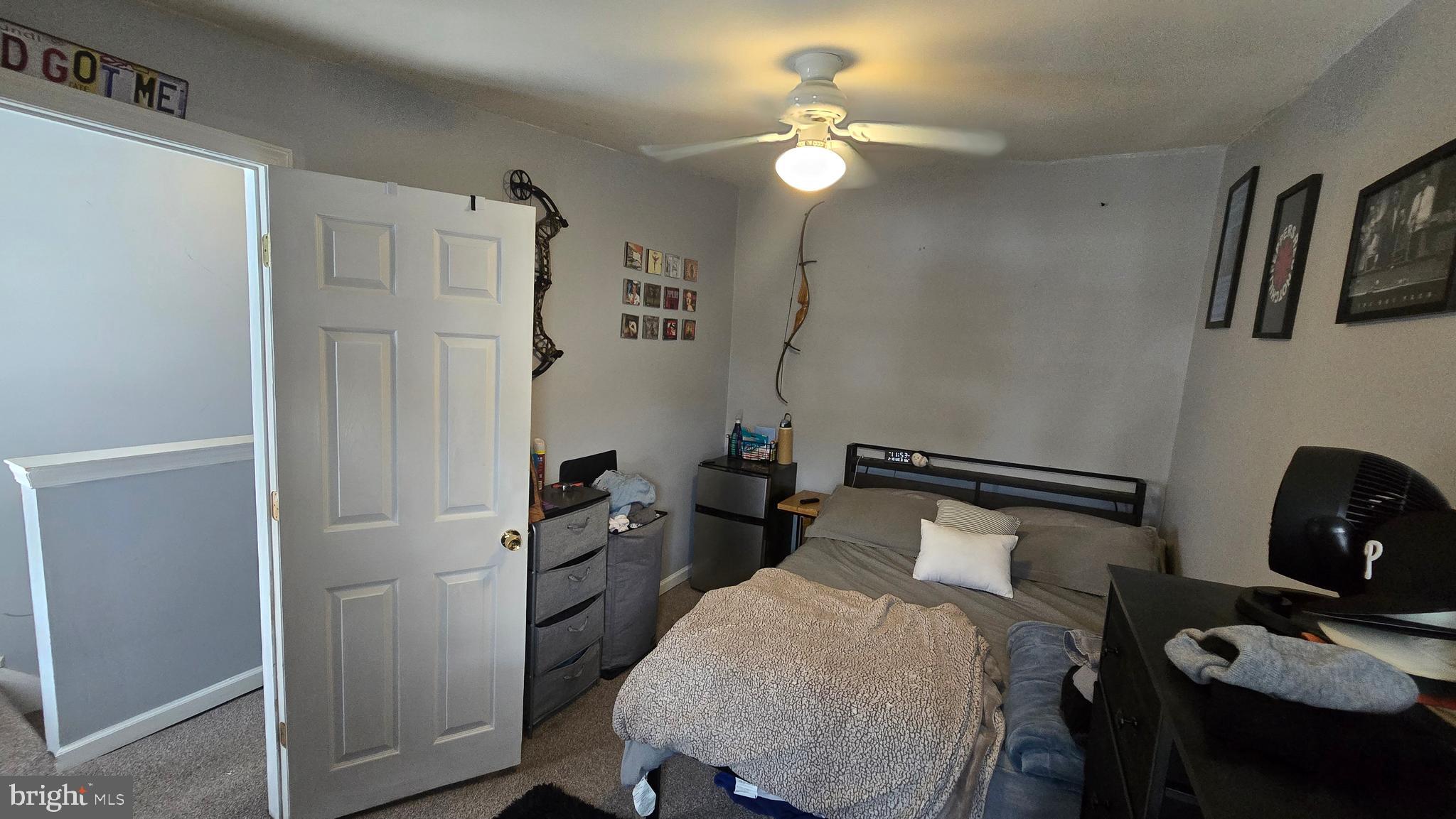 4709 Fowler Street Philadelphia, PA 19127 - Photo 16 of 21 a bedroom with a bed and a chandelier