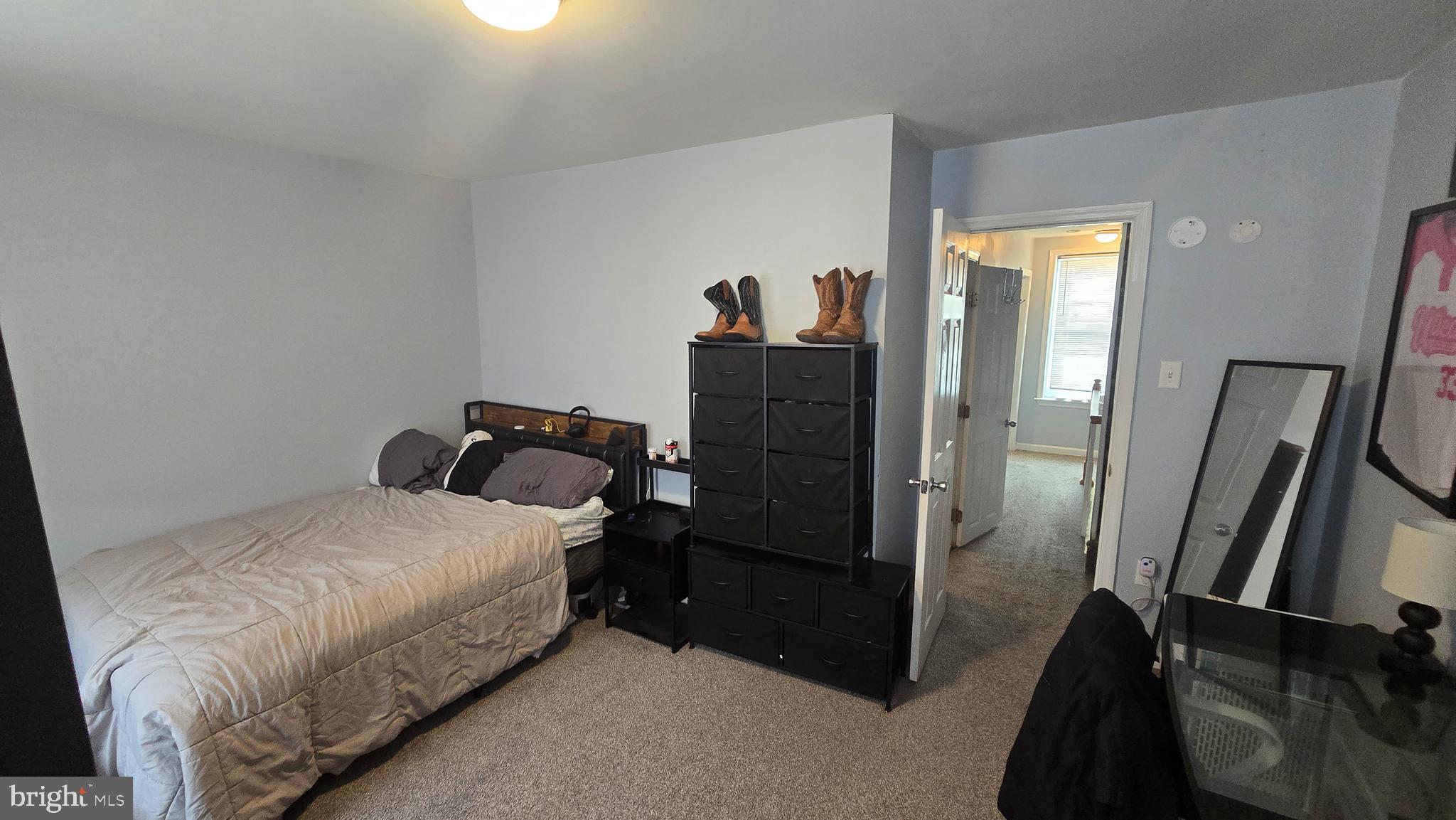 4709 Fowler Street Philadelphia, PA 19127 - Photo 17 of 21 a bedroom with a bed and a mirror