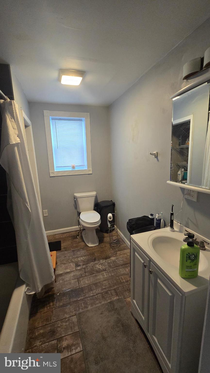 4709 Fowler Street Philadelphia, PA 19127 - Photo 19 of 21 a bathroom with a sink a toilet and mirror