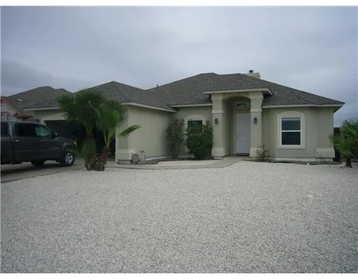 a view of a house with a yard and garage
