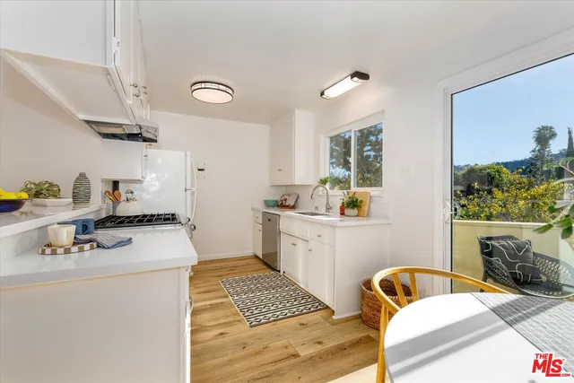a kitchen with a sink appliances and cabinets