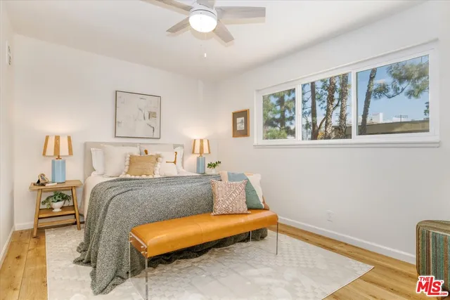 a bedroom with a bed and a painting on the wall