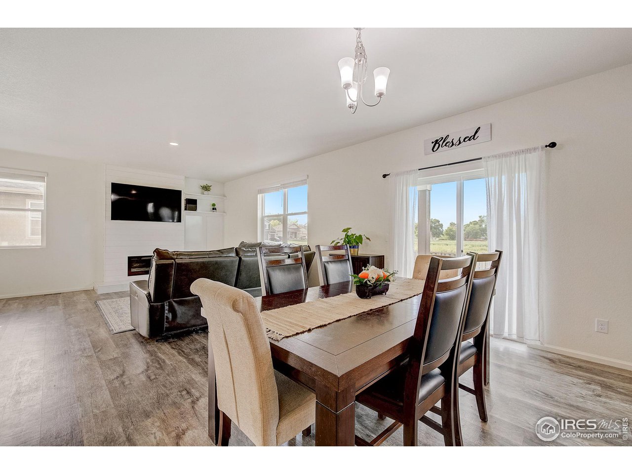 327 Central Avenue Severance, CO 80550 - Photo 11 of 40 a view of a dining room with furniture and wooden floor