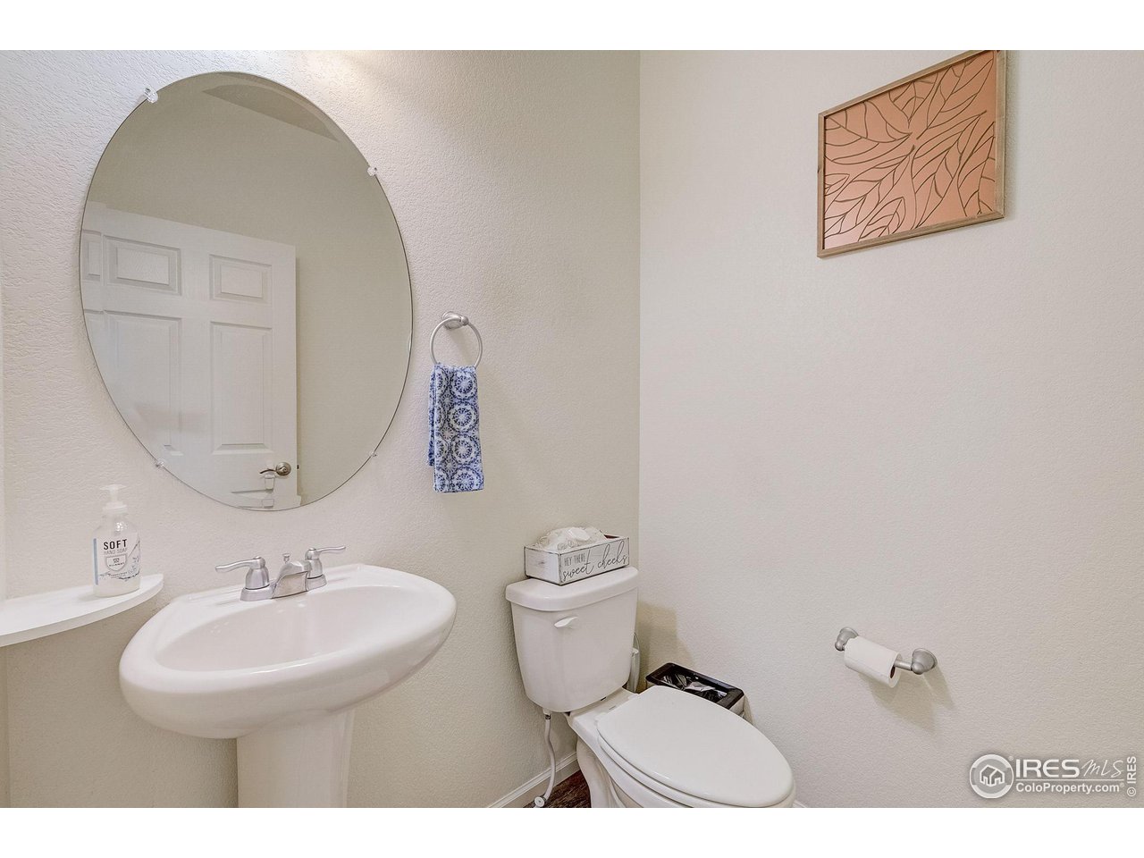 327 Central Avenue Severance, CO 80550 - Photo 18 of 40 a bathroom with a toilet a sink and mirror