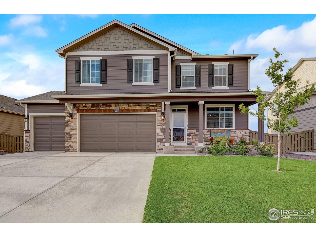 327 Central Avenue Severance, CO 80550 - Photo 2 of 40 a front view of a house with a yard and garage