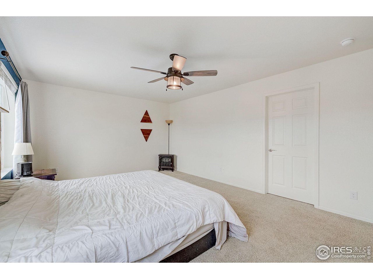 327 Central Avenue Severance, CO 80550 - Photo 23 of 40 a bedroom with a bed and a ceiling fan