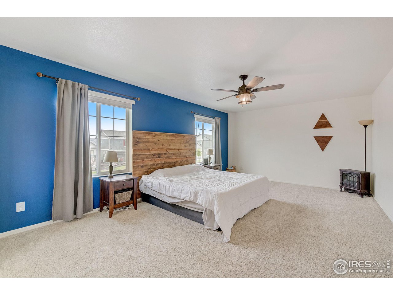 327 Central Avenue Severance, CO 80550 - Photo 24 of 40 a bedroom with a bed and a chandelier