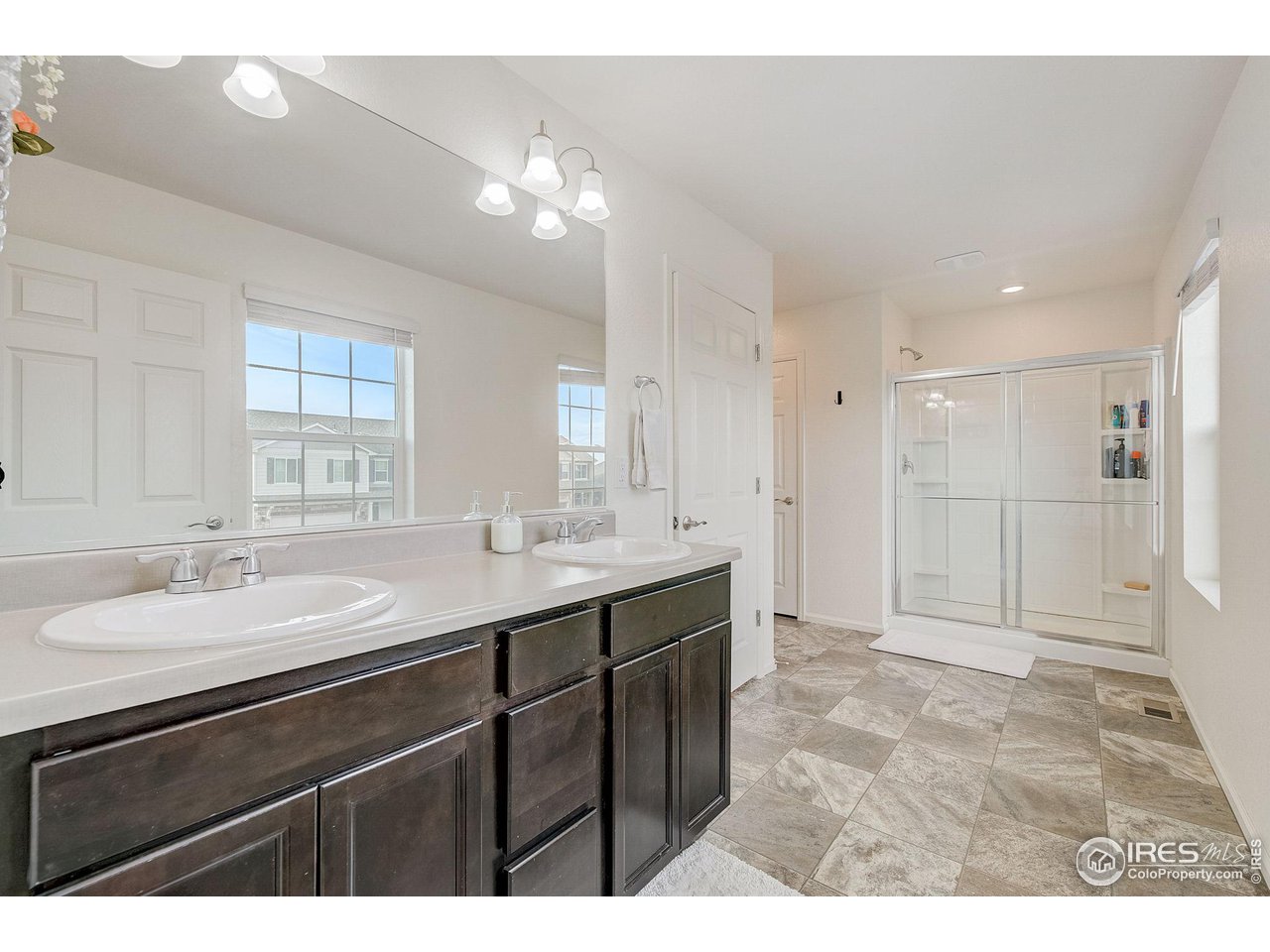 327 Central Avenue Severance, CO 80550 - Photo 27 of 40 a bathroom with a sink double vanity and a mirror