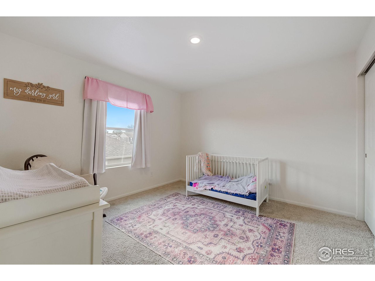 327 Central Avenue Severance, CO 80550 - Photo 30 of 40 a bedroom with a bed and a window