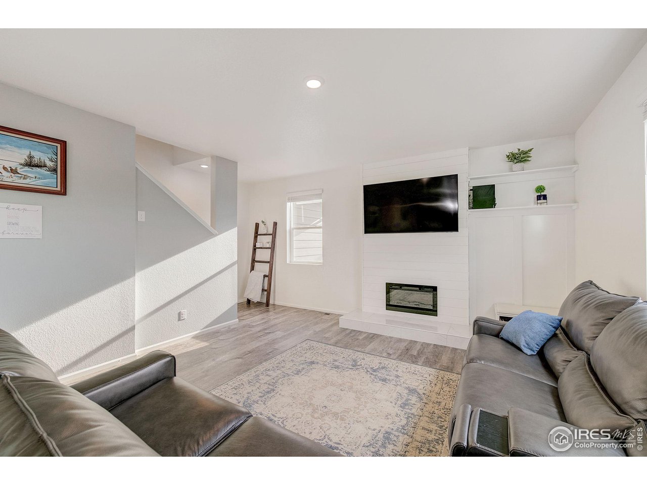 327 Central Avenue Severance, CO 80550 - Photo 5 of 40 a living room with furniture and a flat screen tv