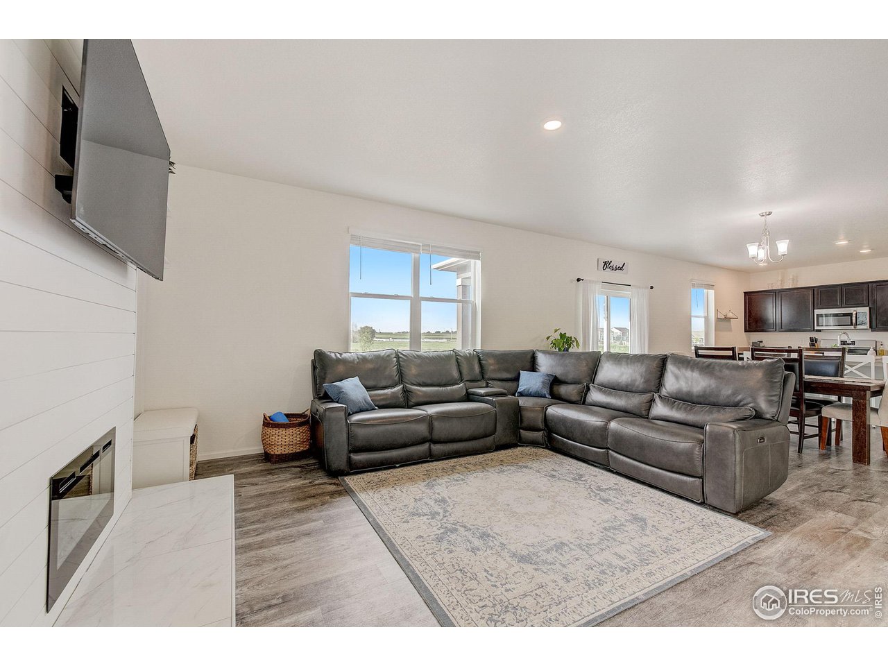 327 Central Avenue Severance, CO 80550 - Photo 6 of 40 a living room with furniture and a flat screen tv