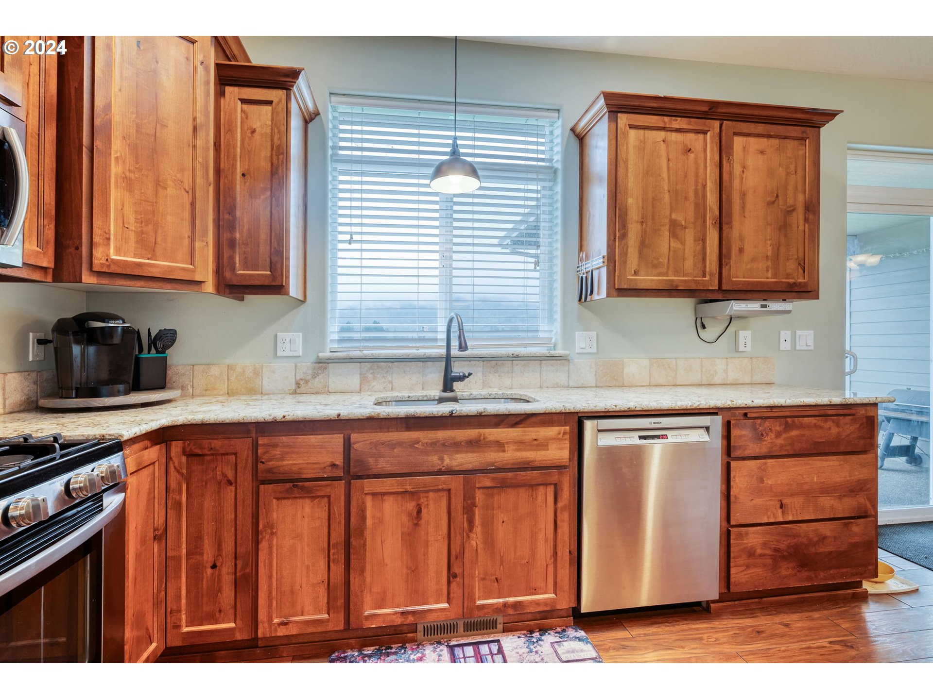 1032 Weaver Road Myrtle Creek, OR 97457 - Photo 11 of 42 a kitchen with stainless steel appliances granite countertop wooden cabinets a sink and a stove
