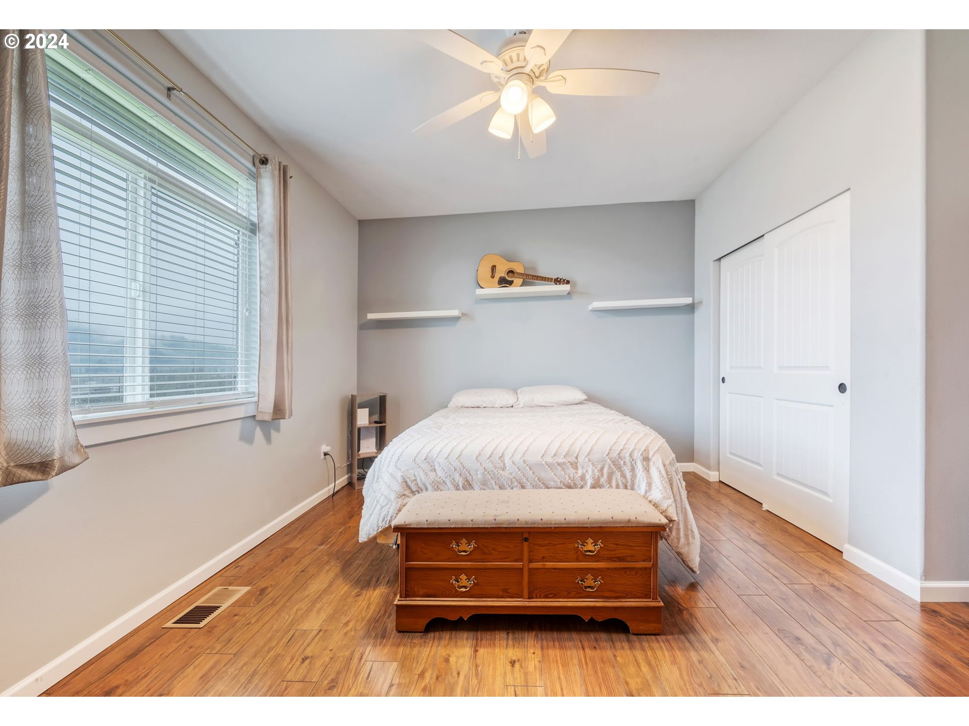 1032 Weaver Road Myrtle Creek, OR 97457 - Photo 19 of 42 a bedroom with a bed and a chandelier