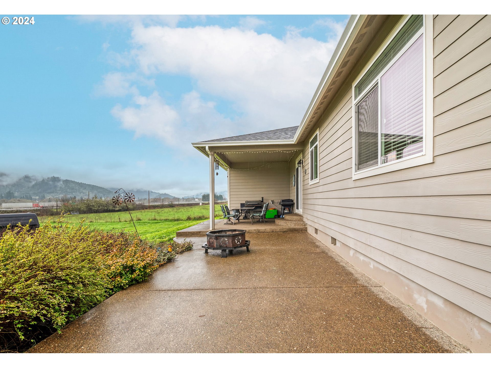 1032 Weaver Road Myrtle Creek, OR 97457 - Photo 29 of 42 a view of a patio with swimming pool and a yard