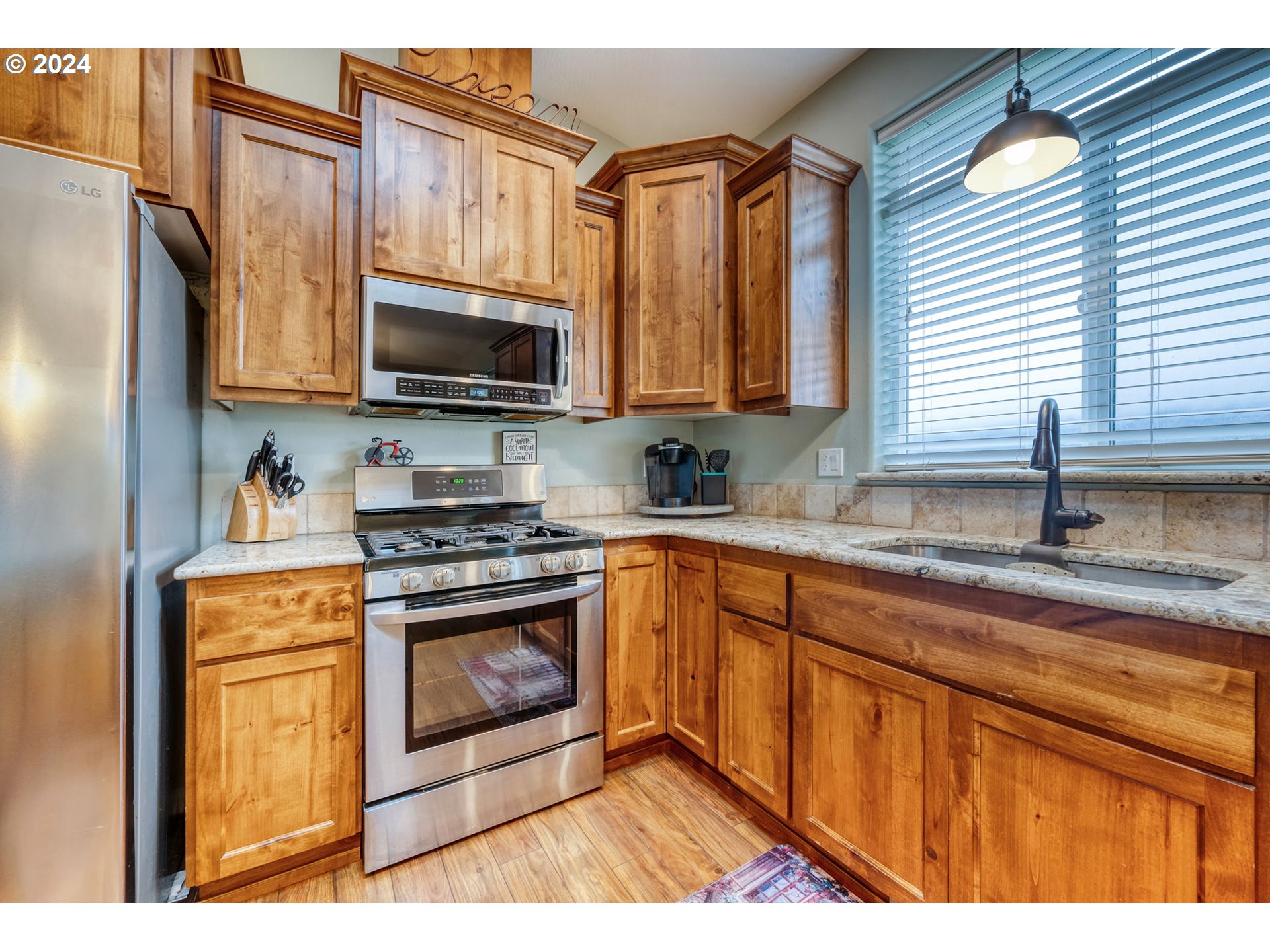 1032 Weaver Road Myrtle Creek, OR 97457 - Photo 10 of 42 a kitchen with stainless steel appliances granite countertop a stove a sink and a microwave