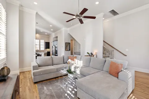 a living room with furniture and a ceiling fan