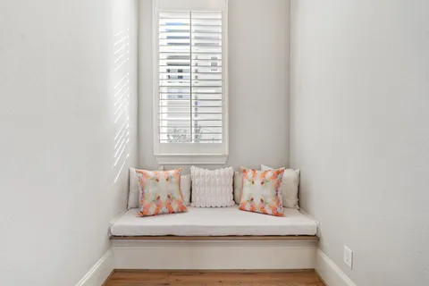 a white couch sitting in a bedroom next to a window