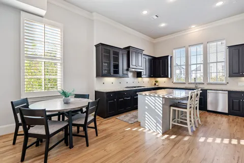 a kitchen with a table chairs stove and cabinets
