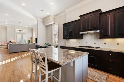 a kitchen with stainless steel appliances kitchen island granite countertop a sink and cabinets