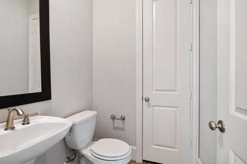 a white toilet sitting next to a bathroom sink