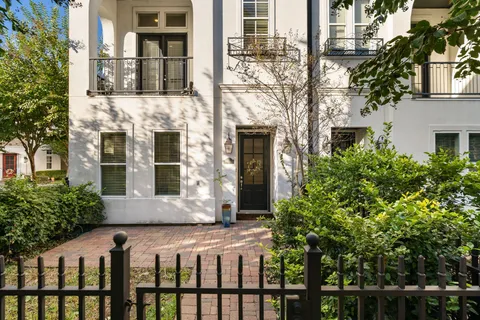 a front view of a building with a garden