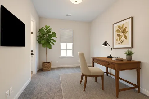 a view of a workspace with furniture and a potted plant