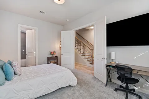 a bedroom with a bed and a flat screen tv