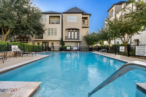 a view of a swimming pool with chairs
