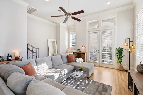 a living room with furniture and a wooden floor