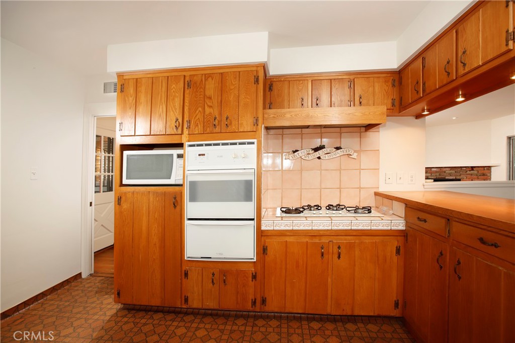 7861 Cora Street Sunland, CA 91040 - Photo 29 of 58 a kitchen with stainless steel appliances granite countertop a refrigerator and a stove