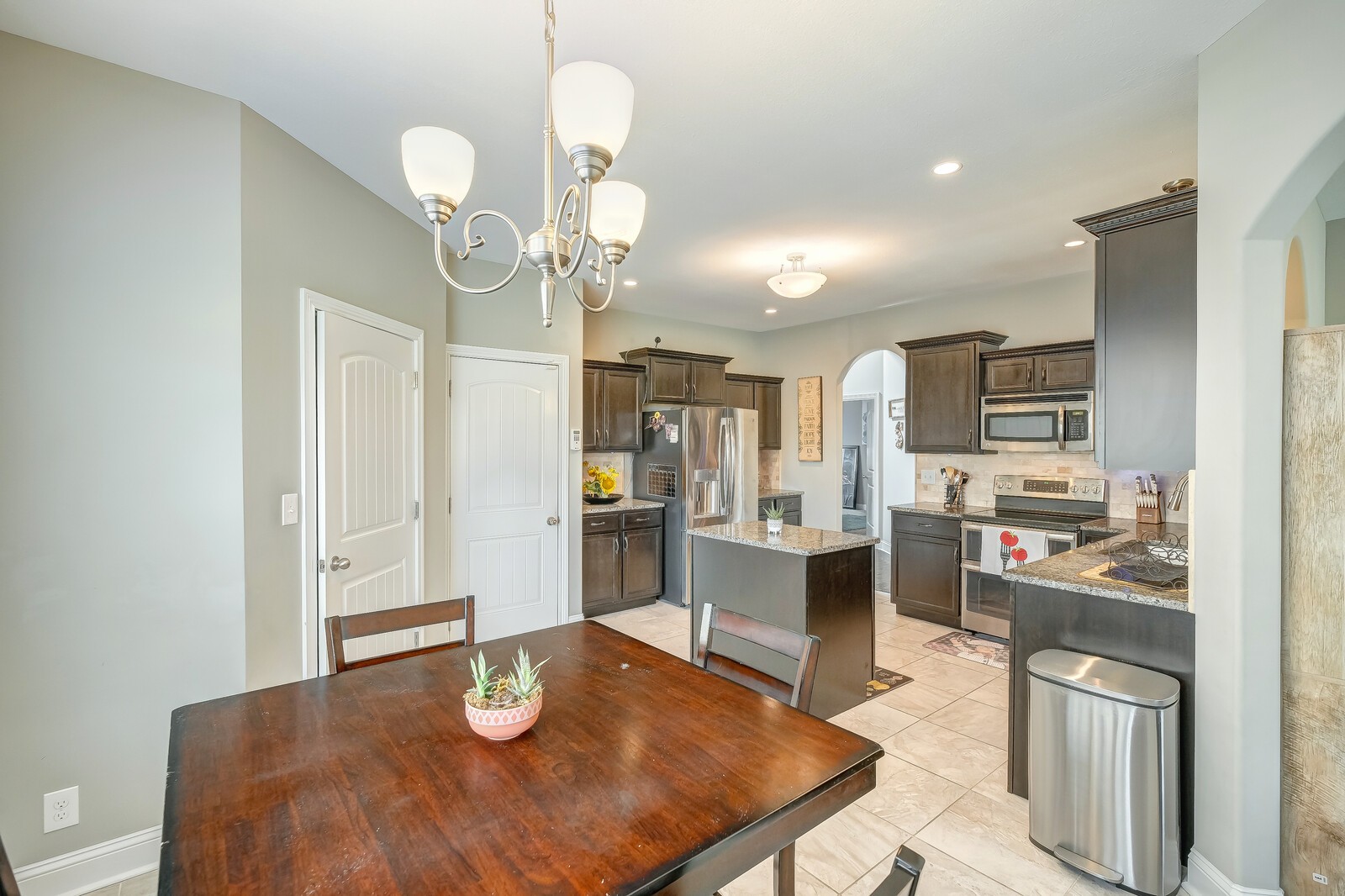 1487 Raven Road Clarksville, TN 37042 - Photo 16 of 44 a kitchen with stainless steel appliances a dining table chairs and stove