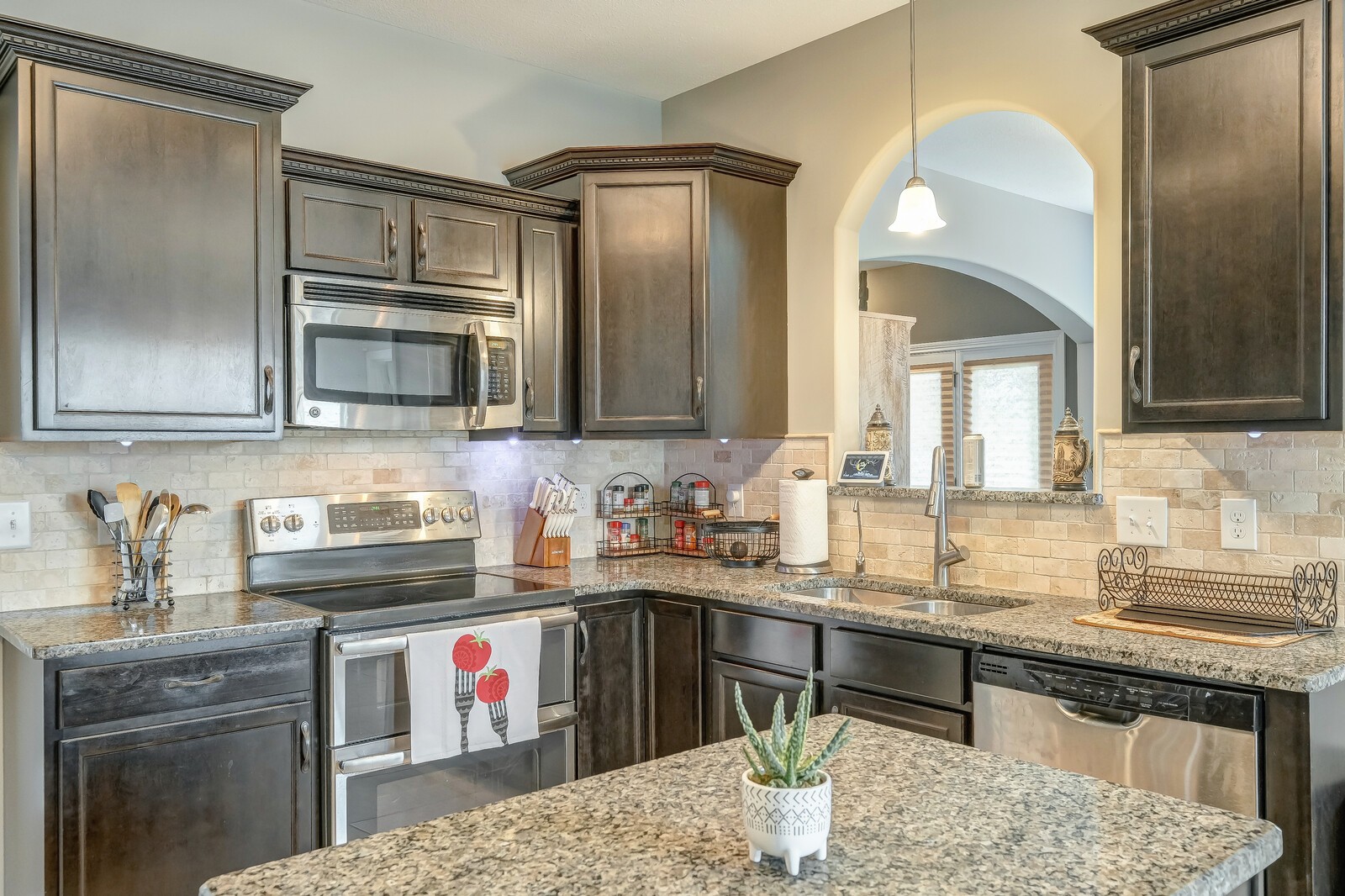 1487 Raven Road Clarksville, TN 37042 - Photo 18 of 44 a kitchen with stainless steel appliances granite countertop a sink stove and cabinets