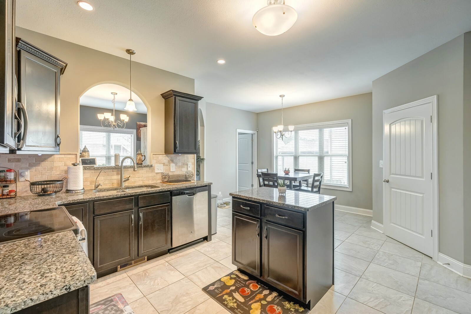 1487 Raven Road Clarksville, TN 37042 - Photo 19 of 44 a large kitchen with kitchen island granite countertop a sink and cabinets