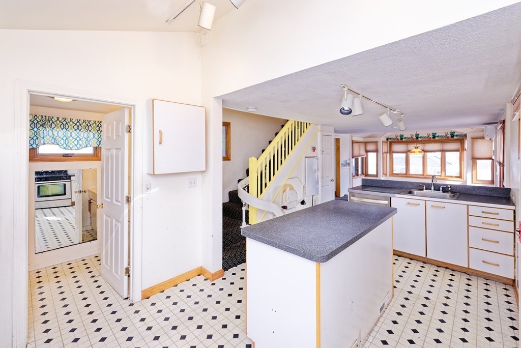22 Union Avenue Wareham, MA 02571 - Photo 8 of 27 a kitchen with granite countertop a refrigerator and a stove top oven