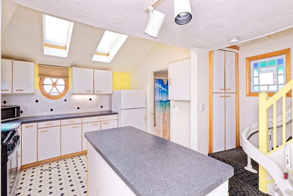 22 Union Avenue Wareham, MA 02571 - Photo 9 of 27 a kitchen with stainless steel appliances granite countertop a sink and a refrigerator