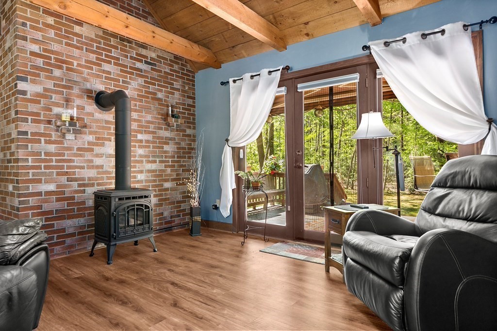 41 Baker Road Salisbury, MA 01952 - Photo 3 of 29 a living room with furniture a fireplace and a floor to ceiling window