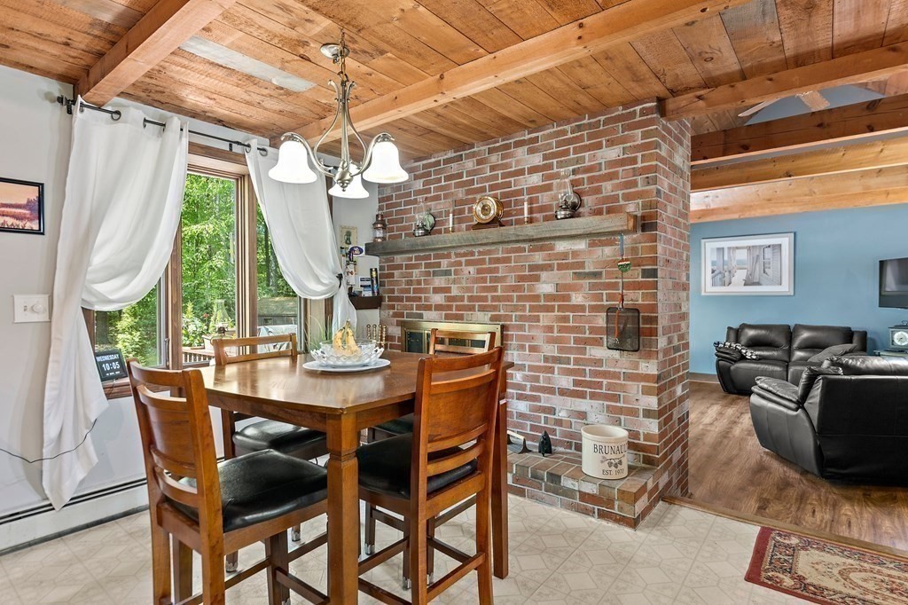 41 Baker Road Salisbury, MA 01952 - Photo 5 of 29 a dining room with furniture a chandelier and wooden floor